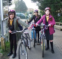 Children walking with their bikes to school