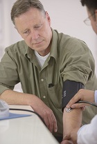 Middle aged man having his blood pressure taken