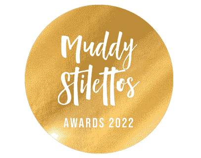 Round gold Muddy Stilettos Awards 2022 logo
