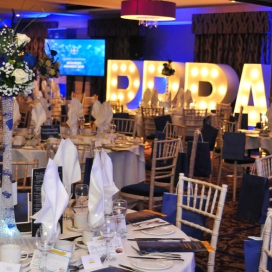 Reigate & Banstead business awards event with tables, chairs and lights
