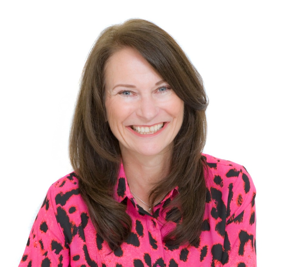 Smiling lady with brown hair and pink spotty shirt
