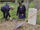 Boy and girl from Dunnottar School tending local war grave