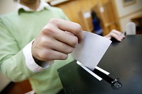 Close up of ballot paper being posted into ballot box