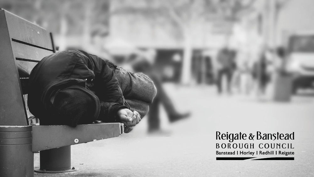 Person sleeping on a bench