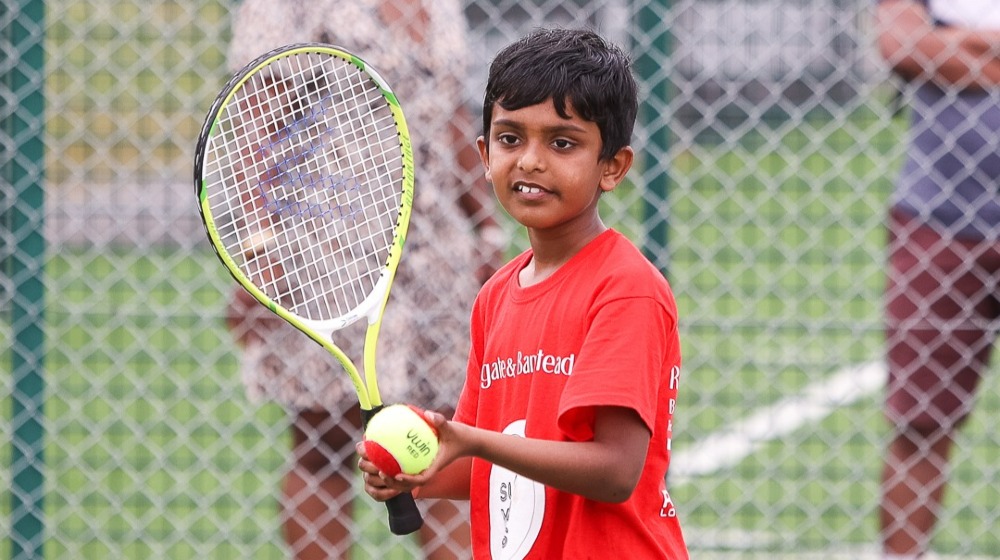 A picture of a boy playing tennis 