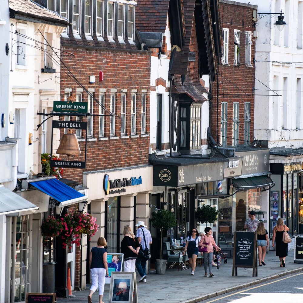 A street view of shops and pedestrians.
