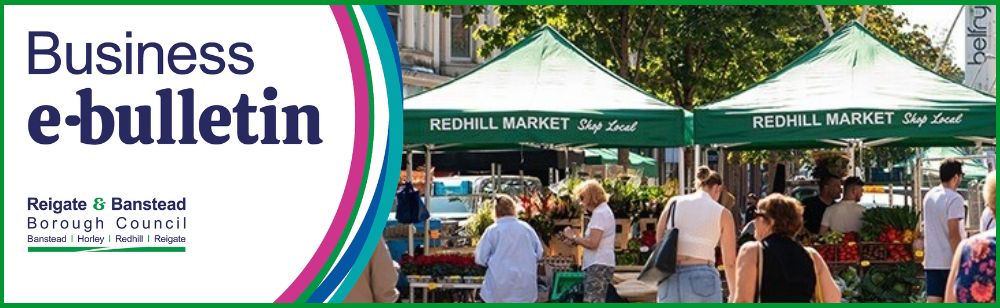 Banner for the Reigate & Banstead Borough Council Business e-bulletin. The left side features the title “Business e-bulletin” and the Reigate & Banstead Borough Council logo. The right side shows a busy outdoor market scene with people browsing stalls under green canopies labelled “Redhill Market – Shop Local,” with flowers, produce and trees visible in the background.
