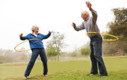 Two older people hula-hooping 