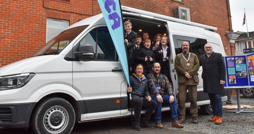 Young people enjoying the new Y bus with (L to R) Left to right: Ian Burks, CEO, YMCA East Surrey, Stuart Kingsley Family Services and Youth Work Manager, YMCA East Surrey, Cllr James Baker, Deputy Mayor, Reigate & Banstead Borough Council, Cllr Richard Biggs, Leader, Reigate & Banstead Borough Council