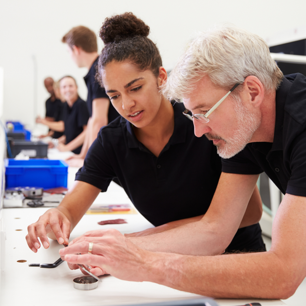 photo of two people looking at components.