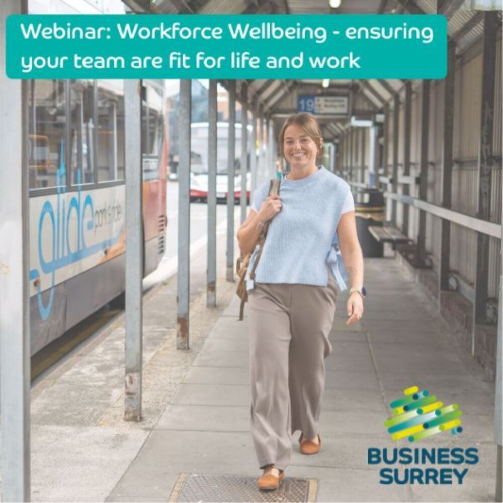 Smiling woman walking at a bus station. Text reads: “Webinar: Workforce Wellbeing – ensuring your team are fit for life and work.” Business Surrey logo shown.