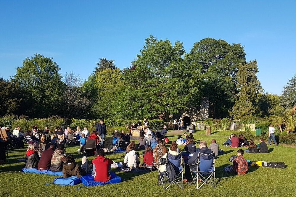 people watching outdoor theatre in the Castle Grounds