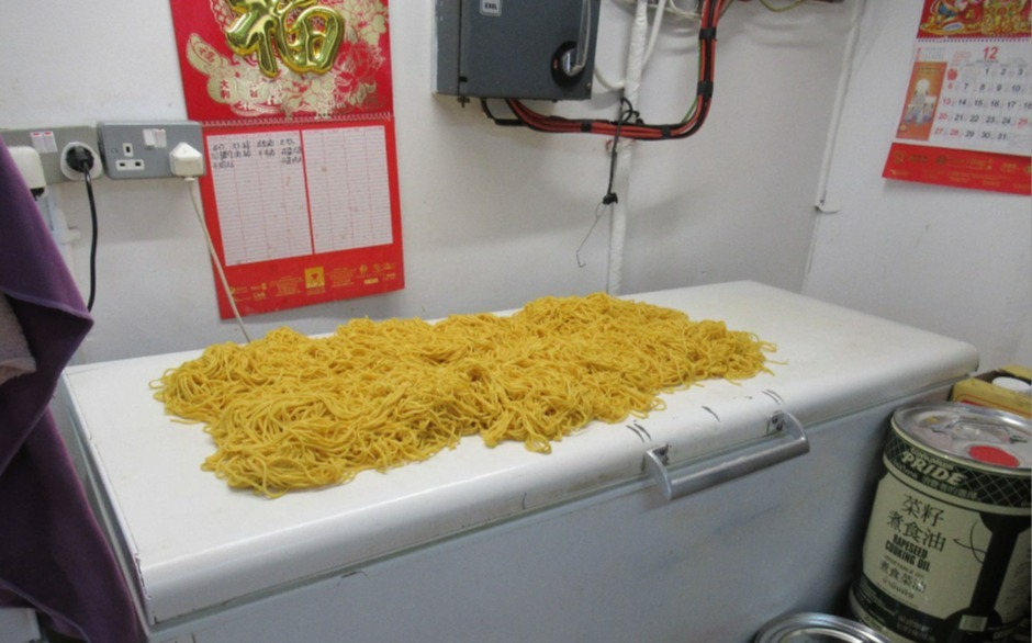 Large pile of noodles left on top of a freezer