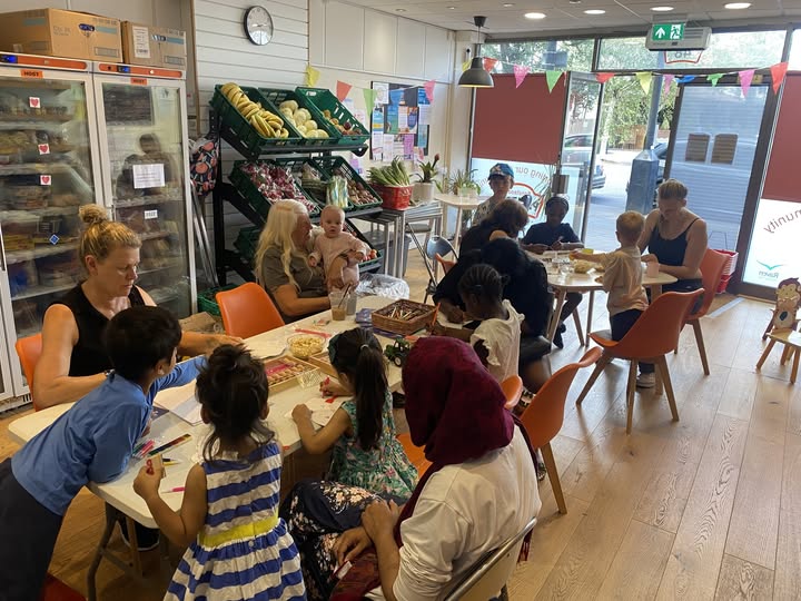 Picture of group of women and children sat at a table